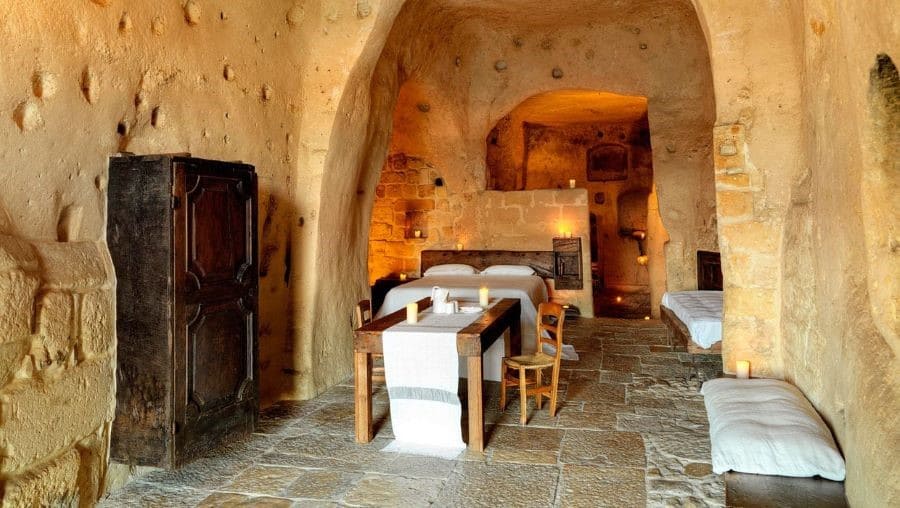 A room in a cave with a bed