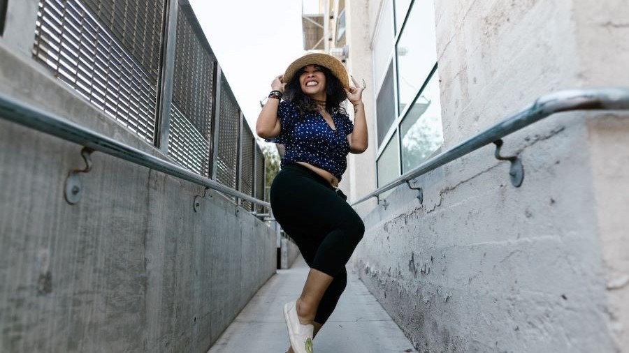 Woman exercising and dancing in an alley